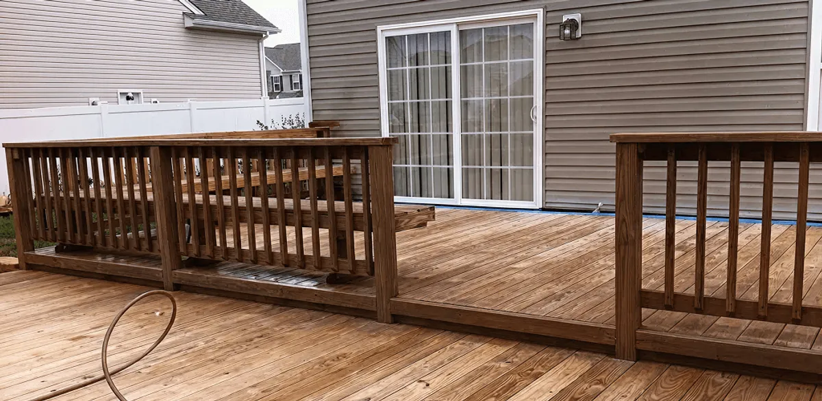 Deck sealing service protecting a backyard wood deck and railings in Baton Rouge, LA
