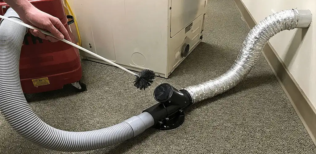 Dryer vent cleaning service removing lint from a dryer duct connection in Baton Rouge, LA