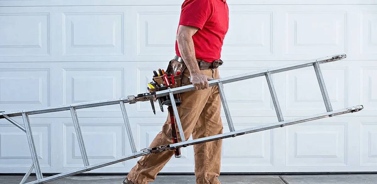 Garage door repair technician arriving with tools and ladder in Baton Rouge, LA