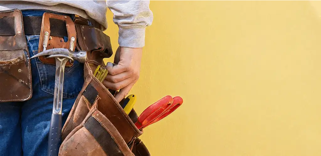 Handyman with tool belt ready for home repairs and maintenance in Baton Rouge, LA