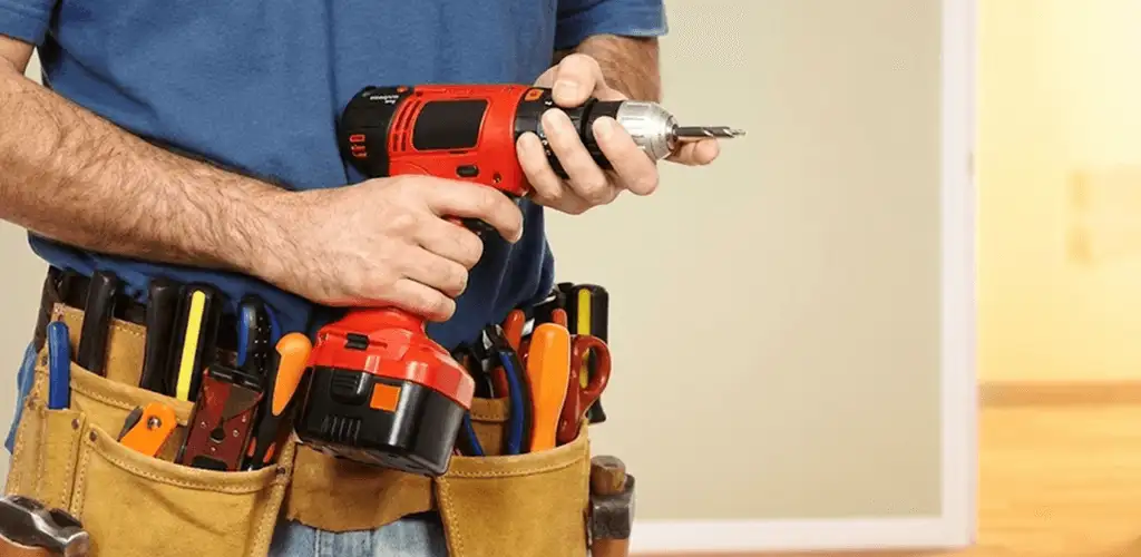 Handyman holding a power drill for home repairs and installations in Baton Rouge, LA