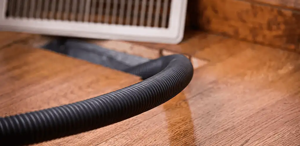 Air duct cleaning hose inserted into a floor vent for ductwork cleaning in Baton Rouge, LA
