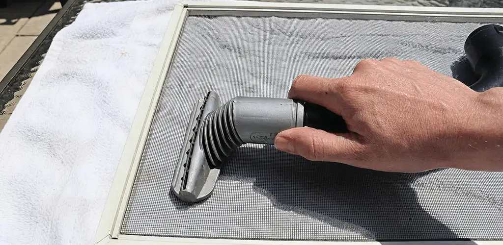 Window screen repair cleaning and fixing a damaged screen mesh in Baton Rouge, LA